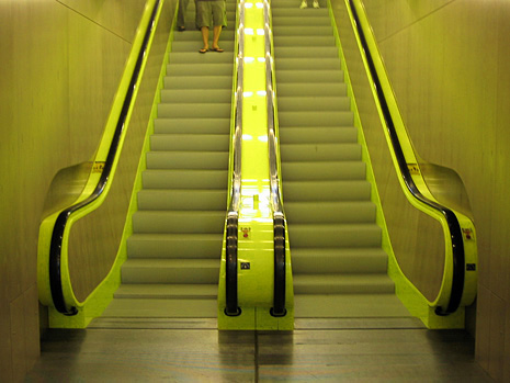 Symmetrical photo of the bright green escalators at Seattle's Central Library